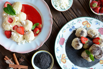 Two plates of Sweet boiled dumplings filled with strawberries with a curd and poppy seed sauce
