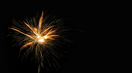 Abstract pyrotechnic glowing explosion on black background. fireworks landscape. Golden flash. Festival card design template.