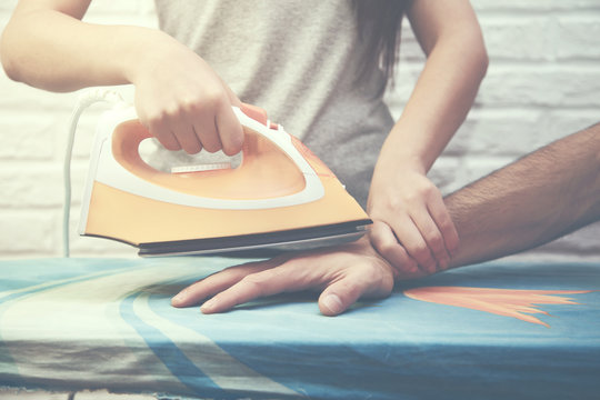 Woman Ironing Man Hand