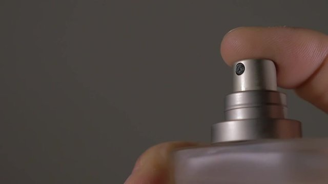 Perfume bottle spray in the dark FullHD 1080p HD footage - Parfum container spraying by the hand in the dark HD 1920X1080 HD video 