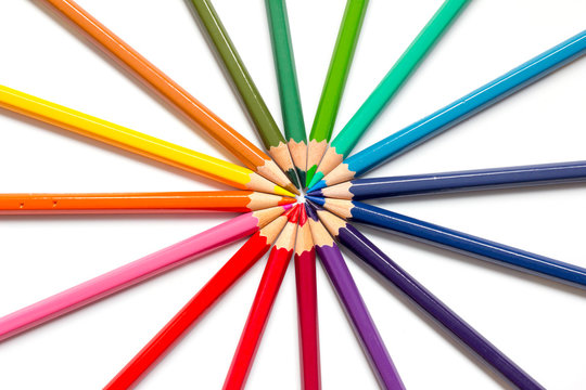 Color pencil placed as sun burst on white background