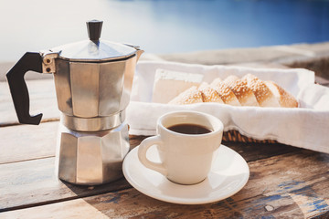 Mediterranean breakfast, cup of coffee, fresh bread and cheese on a table