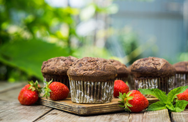 Chocolate muffins on the rustic wooden table. Shallow depth of field.