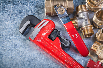 Brass pipe connectors monkey wrench gate valve on metallic backg