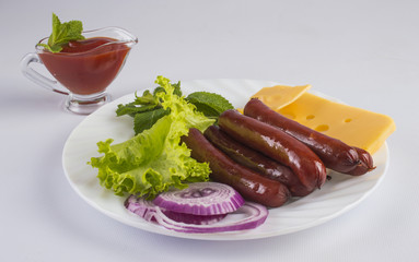 Grilled sausage with herbs, cheese and onions on a white plate.