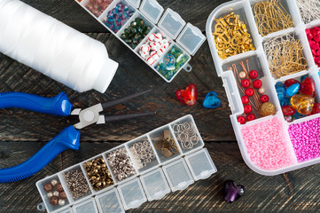 Handmade accessories. Box with beads, pliers and thread