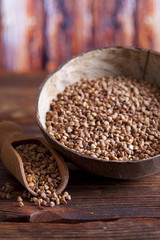 Buckwheat in bowl on wooden table