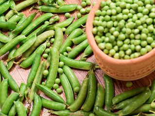 Green peas on the wooden floor.