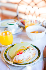 Healthy breakfast with fresh juice and sweet croissant in restaraunt resort outdoor