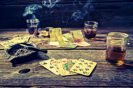 Old illegal gambling table with vodka, cigarettes and cards