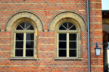 two old windows with bricks and arch