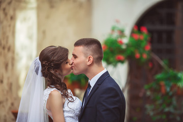 gorgeous wedding couple enjoys a Sunny day in the old town with architecture