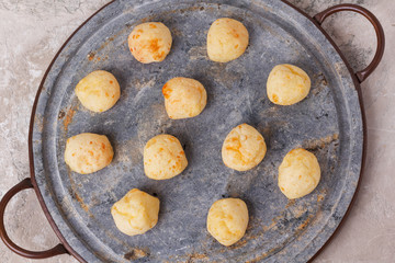 Brazilian snack cheese bread (pao de queijo) on oven-tray