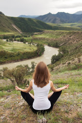 Young Woman Outdoor Meditation. Sitting on the Mountain.