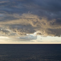 Dark cumulus clouds hovering over the sea