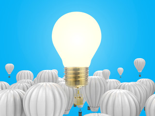 creativity concept with shiny light bulb above hot air balloons