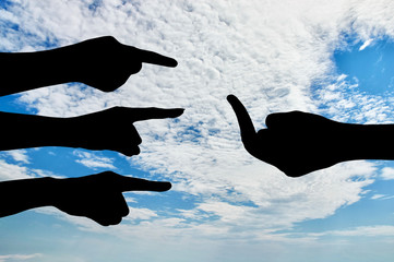 Silhouette of hands pointing, denouncing the hand that shows the gesture in response to fuck you.