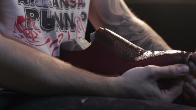 Shoemaker sews shoes