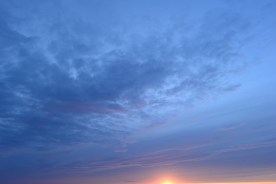 Blue cloudy sky at sunset on a summer evening