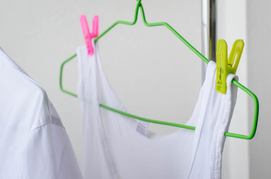 white shirts drying on a clothes line.