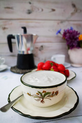 Breakfast served in a terrace - coffee, natural yogurt, strawberry