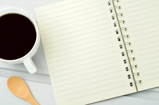 Empty notepad with coffee cup