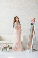 Portrait of beautiful pregnant woman in studio