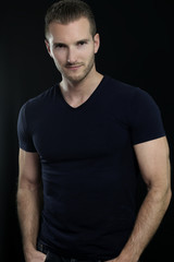 Fototapeta premium Handsome man posing over a black background