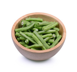 Slices yardlong bean in wood bowl isolated on white background.