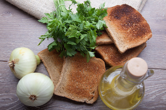 bread onion and olive oil on table