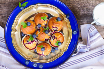 plate of cupcakes with blueberry with milk close up
