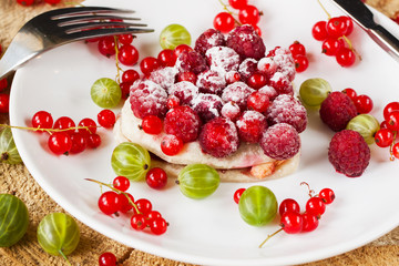 Fruit tart on white plate, viewed from above