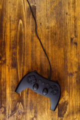 Game pad controller on wooden desk, flat lay top view