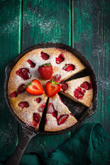 Fototapeta na wymiar rstic summer strawberry cake on cast iron pan