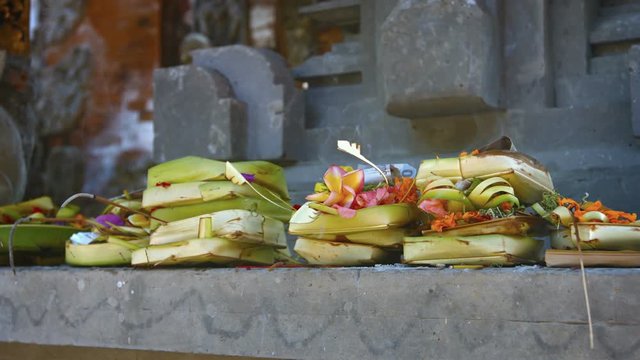 Insense smoke rises from amongst the offerings on the long shelf of an altar at a Hindu Temple. Video 4k