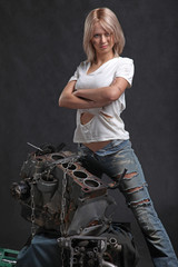 Obraz na płótnie Canvas girl in engine oil with wrench key