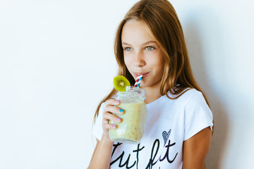 Kid girl drinking smoothie
