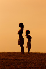 Silhouette of a angry mother and daughter on each other. 