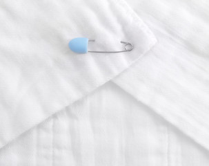 Baby cloth diaper with a blue safety pin