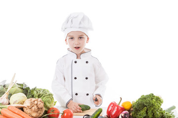 One little boy as chef cook making salad, cooking with vegetable