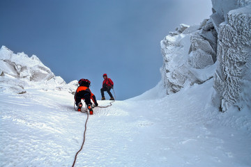 Climbing in mountains. Team work.