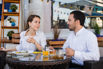 Happy business people on their lunch outside at the coffee shop