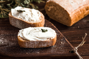 Slices of Ciabatta with cottage cheese and herbs