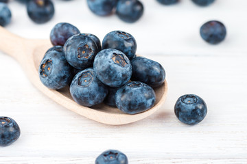 blueberry on wooden spoon, close-up