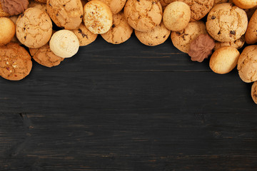 Cookies and biscuits at black wood with copy space