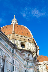 Fototapeta na wymiar Dome of cathedral church Santa Maria del Fiore over blue sky, Florence, Italy