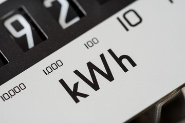 Close-up of kilowatt hour electric meter. Concept for cost of living crisis, high prices, billing,...