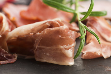 a pile of different spanish embutido, jamon, chorizo and lomo em