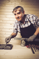 Senior carpenter working in his workshop
