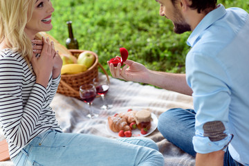 Happy guy is proposing marriage to girlfriend